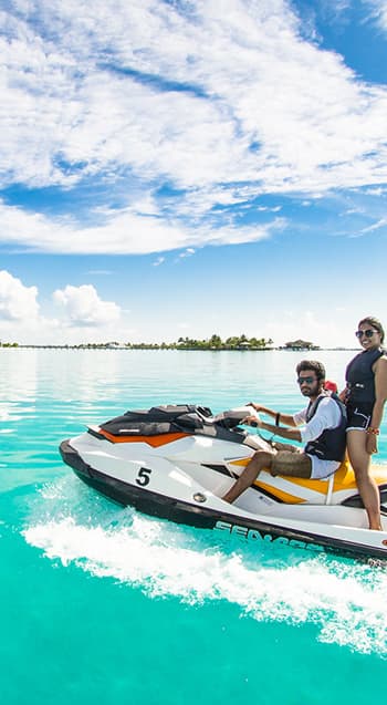 couple on a water scooter on sea